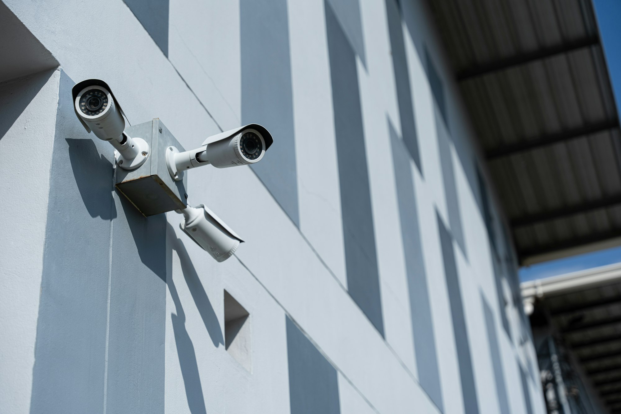 Security surveillance camera in front of office building. CCTV, Closed-circuit television security.